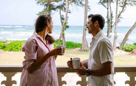 Couple drinking coffee on the lanai at Aston Maui Hill.