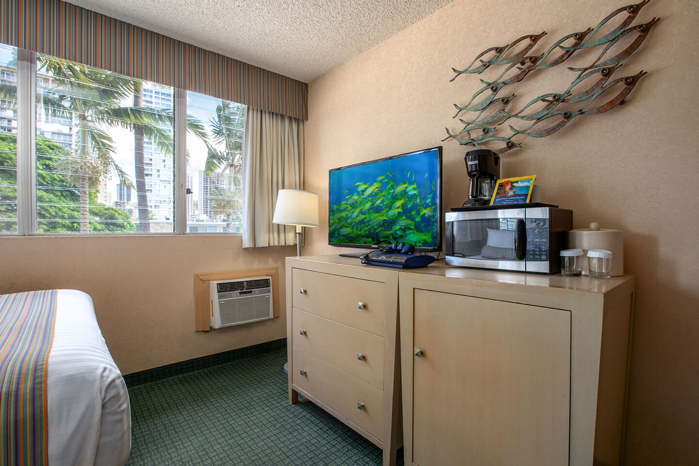 Moderate hotel room with TV, microwave, and coffee maker.