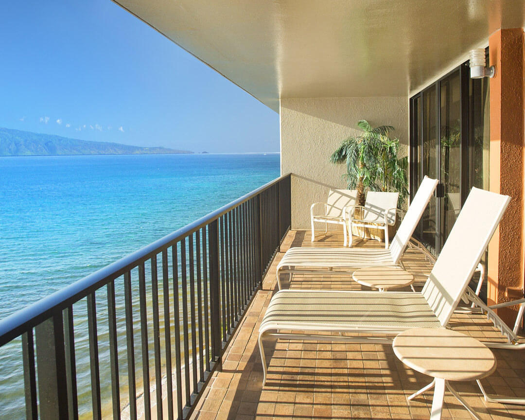 Balcony with chair overlooking the ocean.
