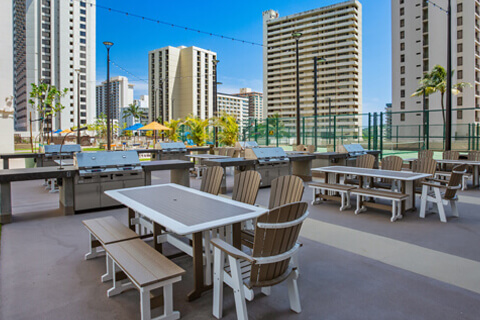 Deck with barbecue grills and sitting area.