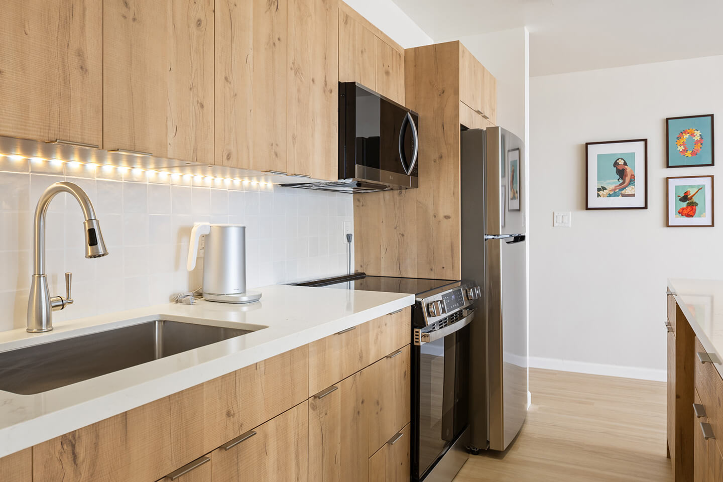 Kitchen with new stove, microwave and refrigerator.