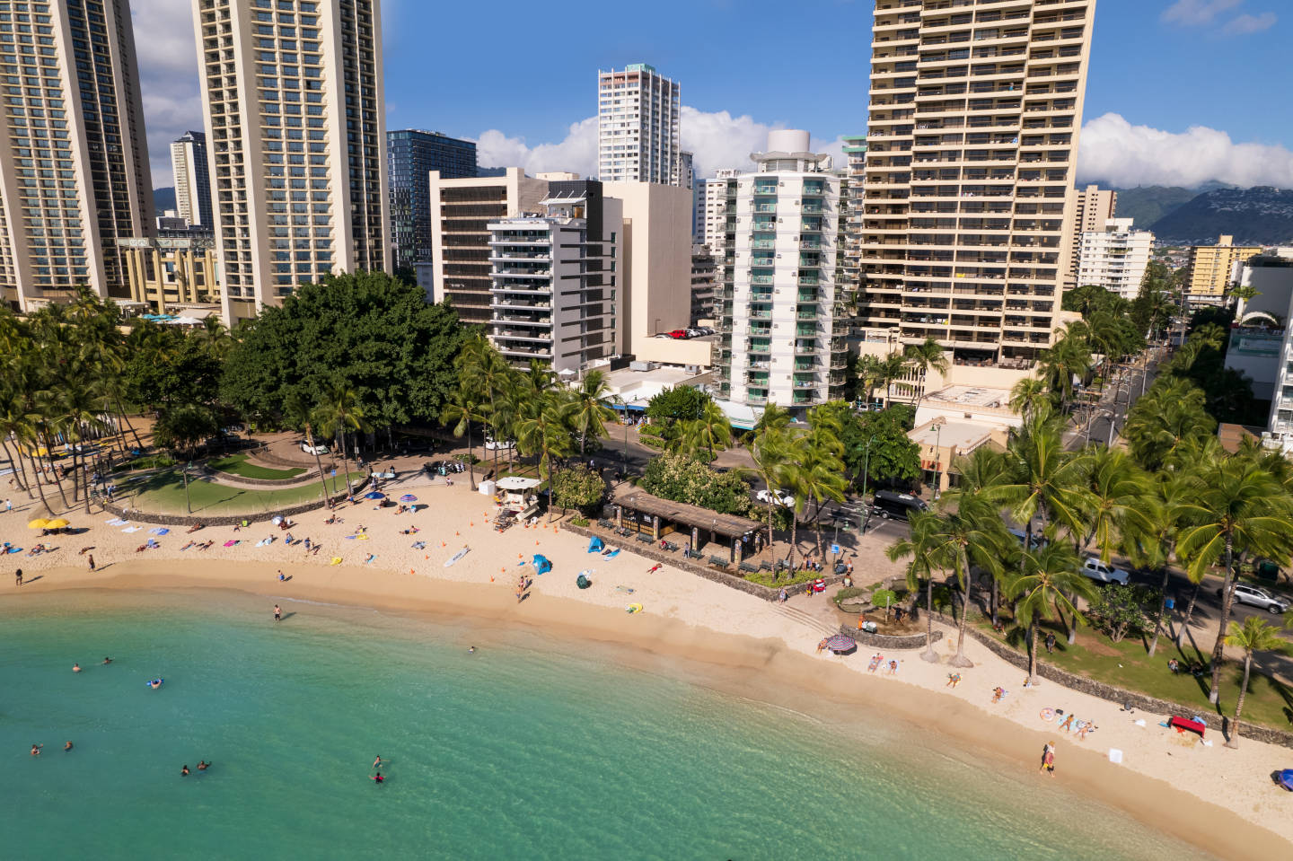Overhead view of Waikiki beachfront and cityscape.