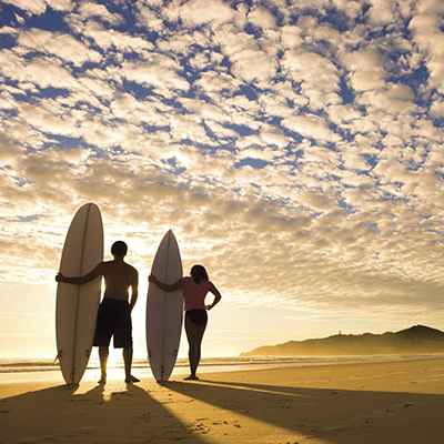 Couple surfing Oahu Waikiki Hawaii