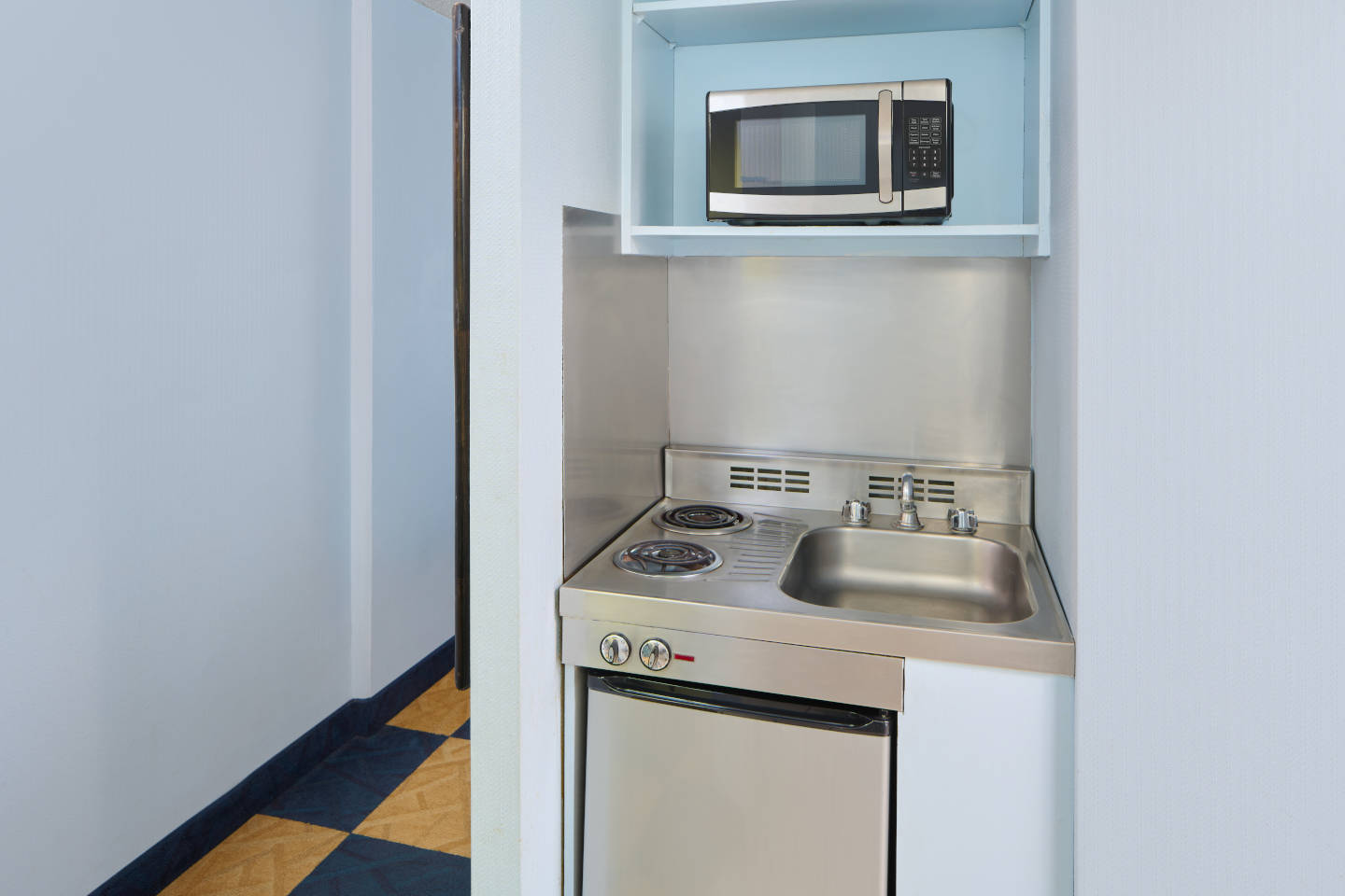Kitchenette in Studio unit with balcony amenities.