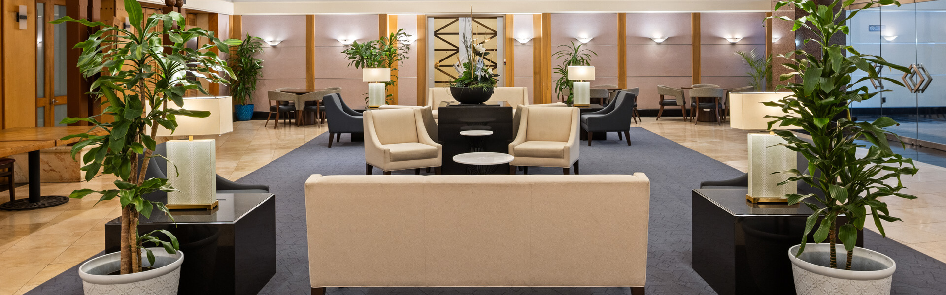 Lobby with seating, tables, plants