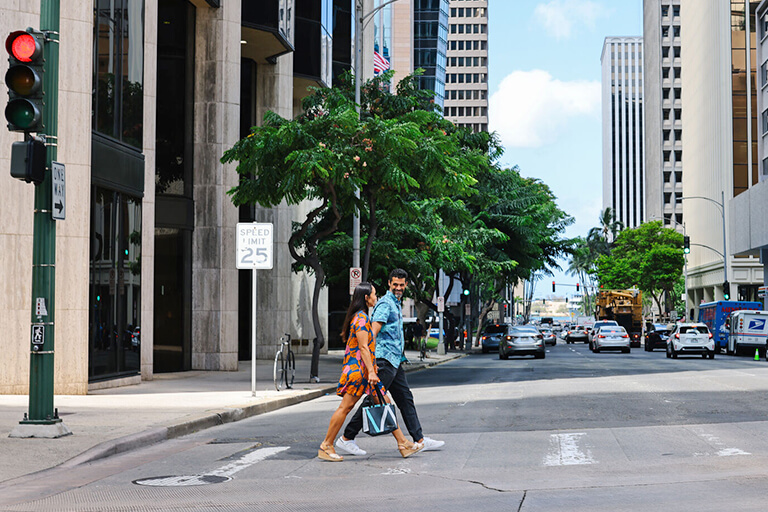 Peope walking through downtown crosswalk.