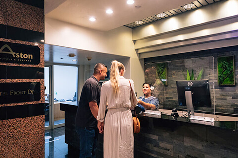 Couple checking-in at front desk.
