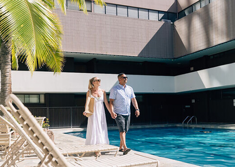 Couple walking on pool deck