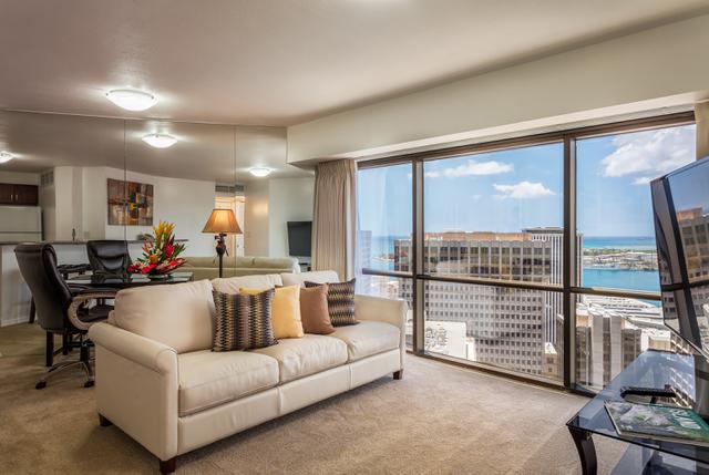 Living area with couch, dining area, TV, harbor views