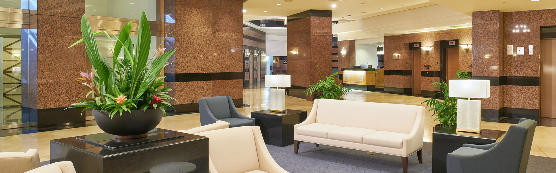 Lobby with seating, tables, plants