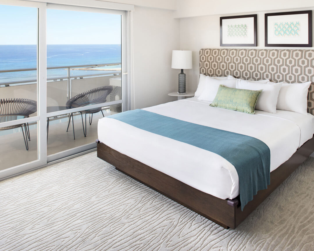 Bedroom with balcony overlooking the ocean.