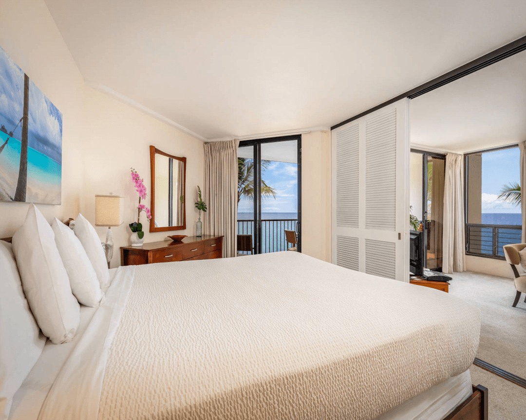 Bedroom with balcony overlooking the ocean.