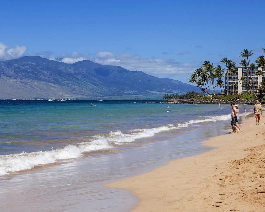 Sandy beach and ocean next to Aston Maui Banyan.
