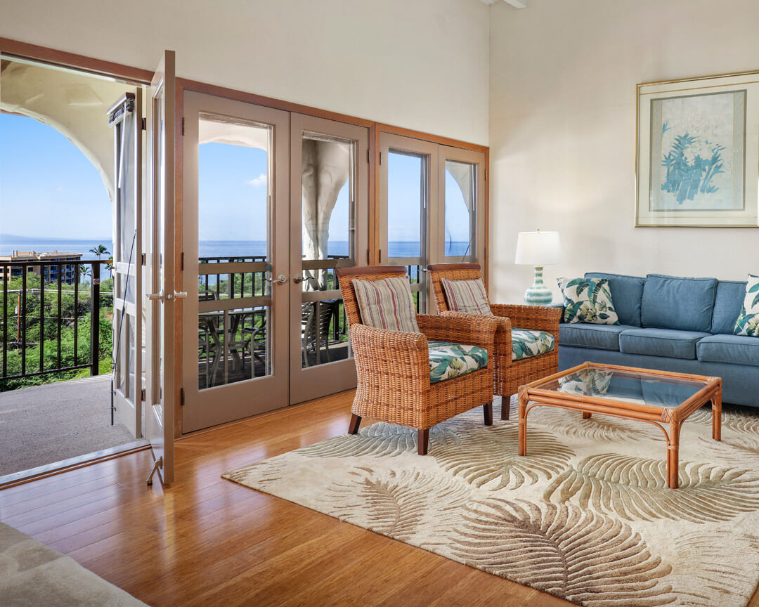 Livingroom with sofa, chairs, coffee table, and lanai with a view.