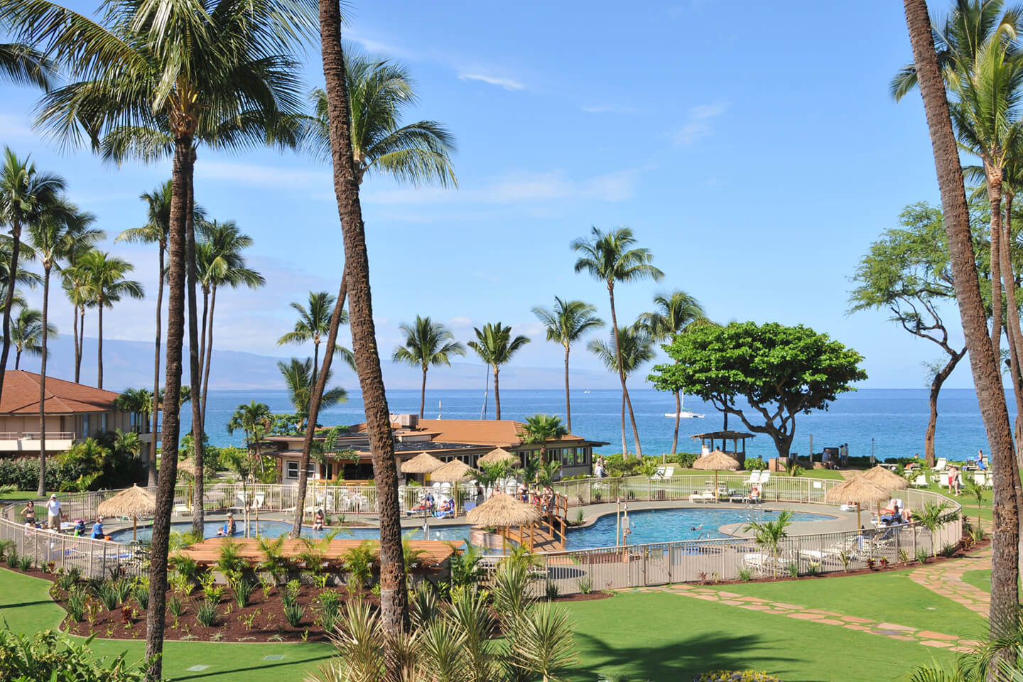 View of the pool and lush landscape along the pathway