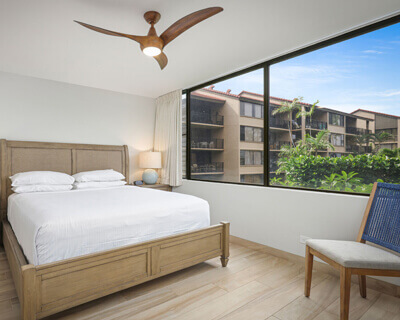 Room with a bed, lamps, and large window.