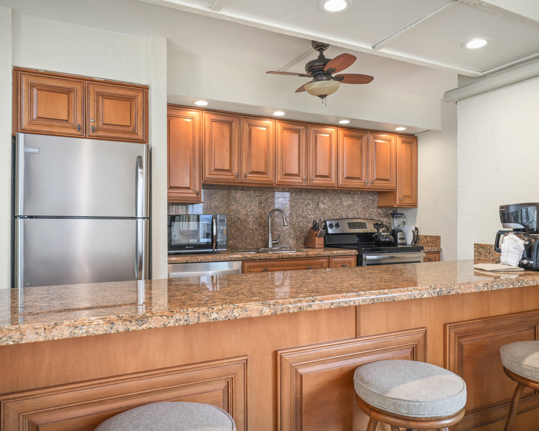 Full-sized kitchen with granite countertops.