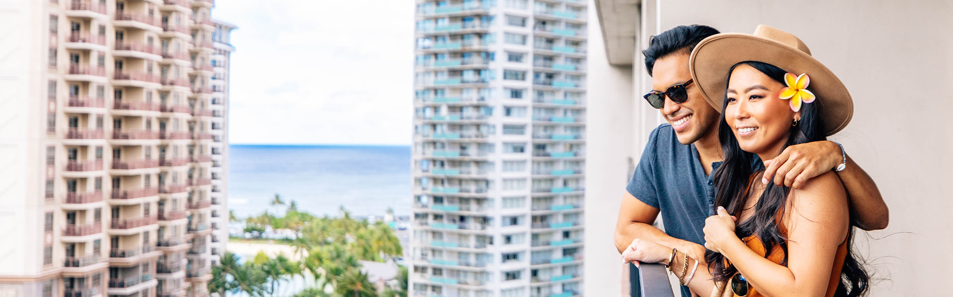 Couple on balcony looking at views