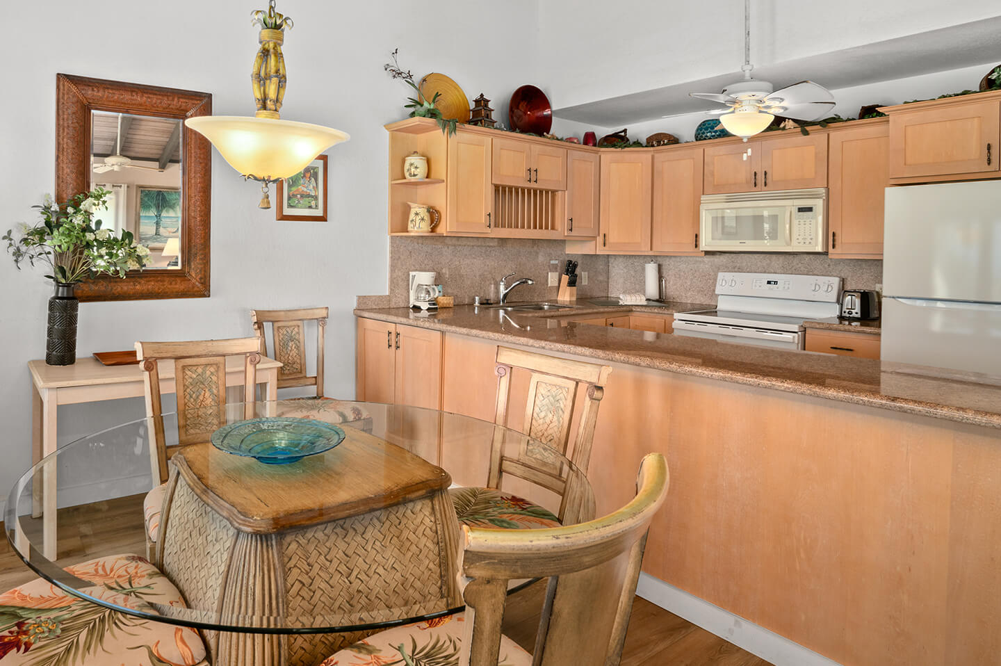 Kitchen counter top, stove, refrigerator, sink, microwave.