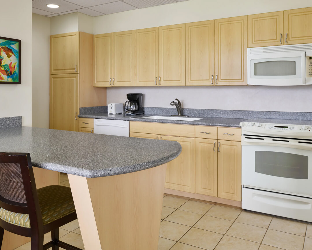 Kitchen with stove, microwave and counterspace.