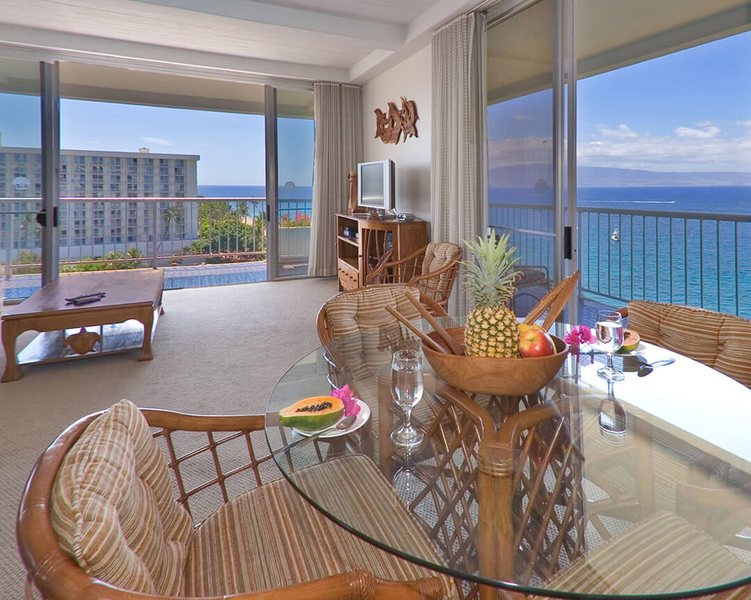 Living and dining area with large windows overlooking the ocean.